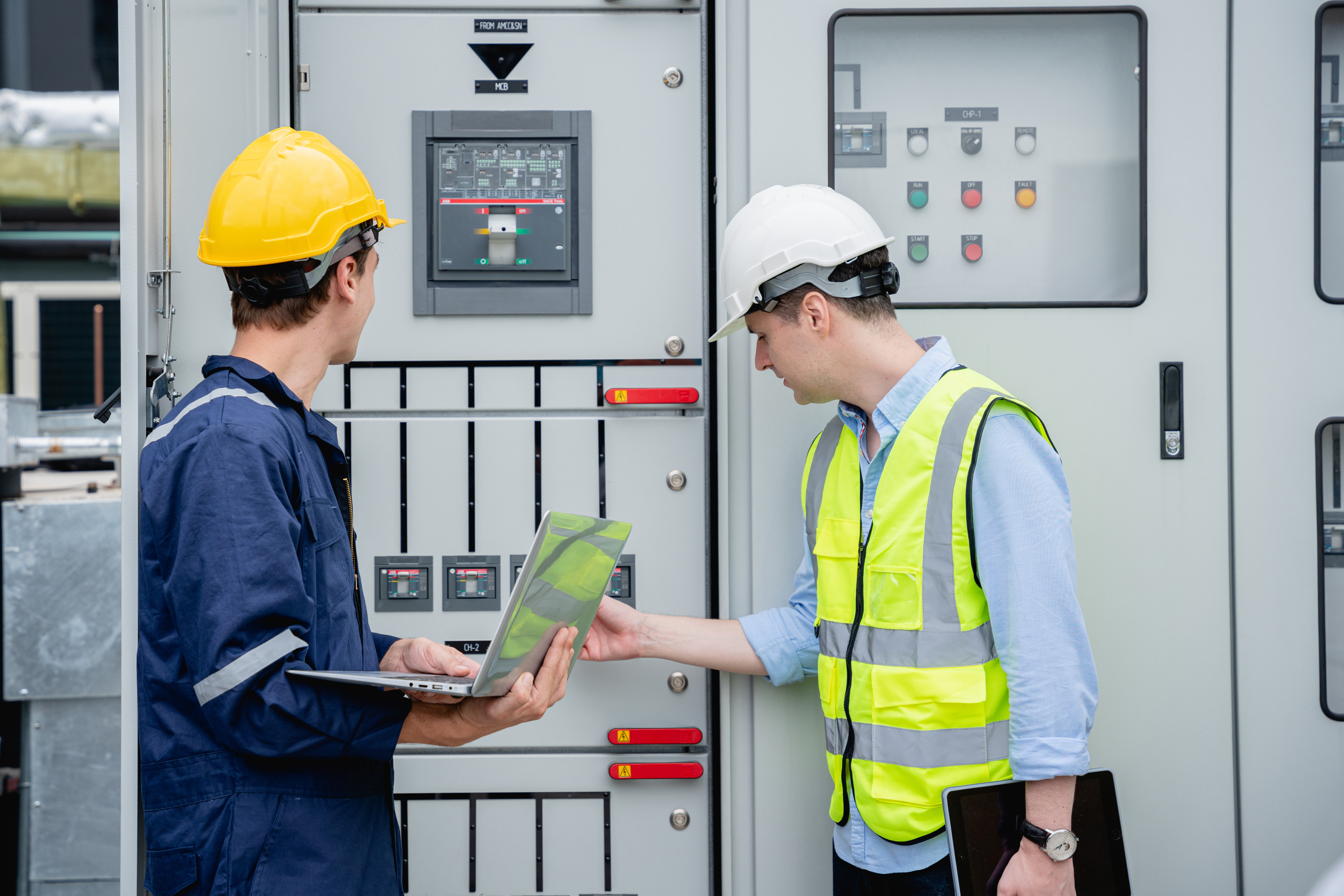 Commercial electricians reviewing industrial electrical panel in Fort Worth Texas by BemossTX